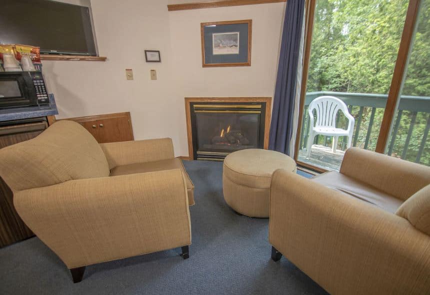 inside of a suite with fire place and sofas at The Ridges Inn & Suites, Door County
