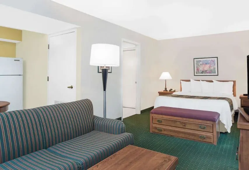 premium room with cozy bed and sofa at Hawthorn Suites by Wyndham Green Bay, Wisconsin