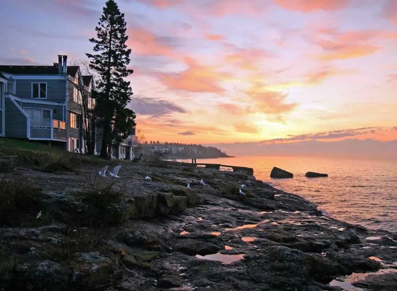 Cabins on Lake Superior Wisconsin, cabin at sunset with seagulls on a rocky beach