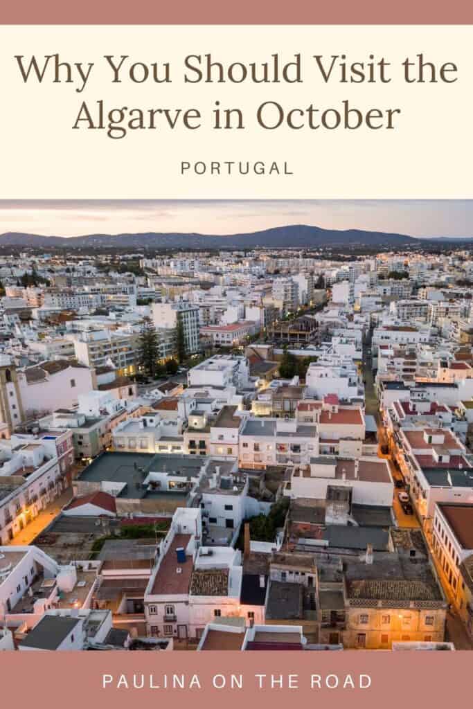 Pin with aerial shot of large built up area of densely packed white residential and office buildings stretching off into the distance towards a backdrop of dark rolling hills under a dusk sky, caption reads: Why You Should Visit the Algarve in October Portugal from paulinaontheroad.com