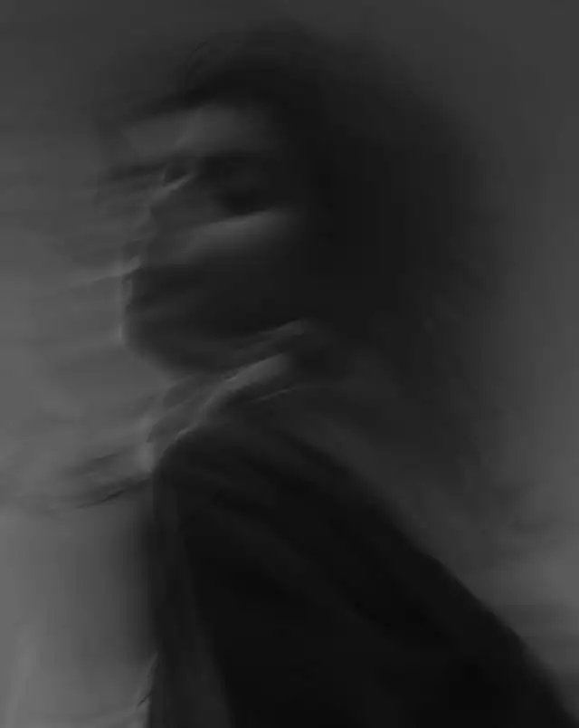 Blurry black and white outline of woman's side profile