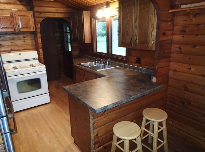 a wooden kitchen at the Secluded Log Home in Wausau, Wisconsin