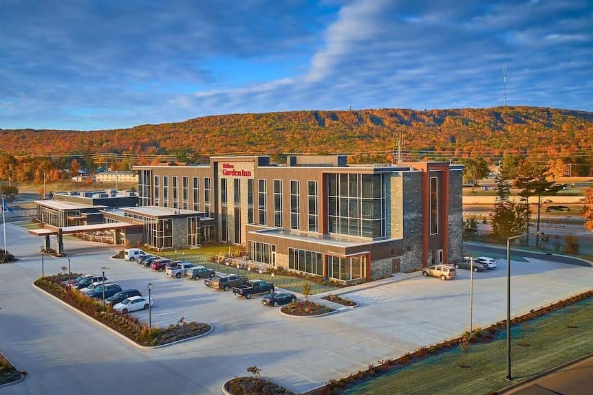 aerial view of the Hilton Garden Inn, Wausau with parking lot and forest in the distance.