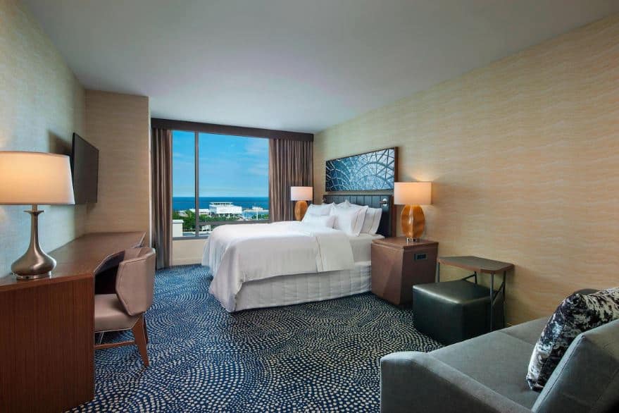 bedroom with sofa, desk and city view at The Westin Milwaukee, Wisconsin