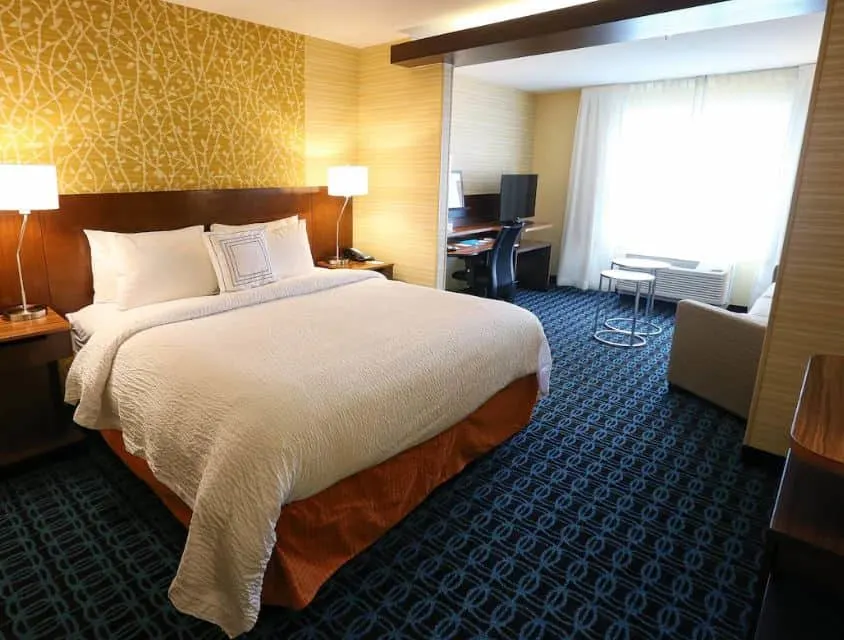 bedroom with sofa, desk and cozy bed at Fairfield Inn & Suites by Marriott Madison, Verona