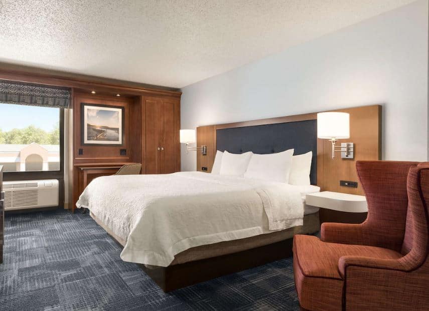 cozy bedroom with armchair and bed at Hampton Inn, Wausau, Wisconsin