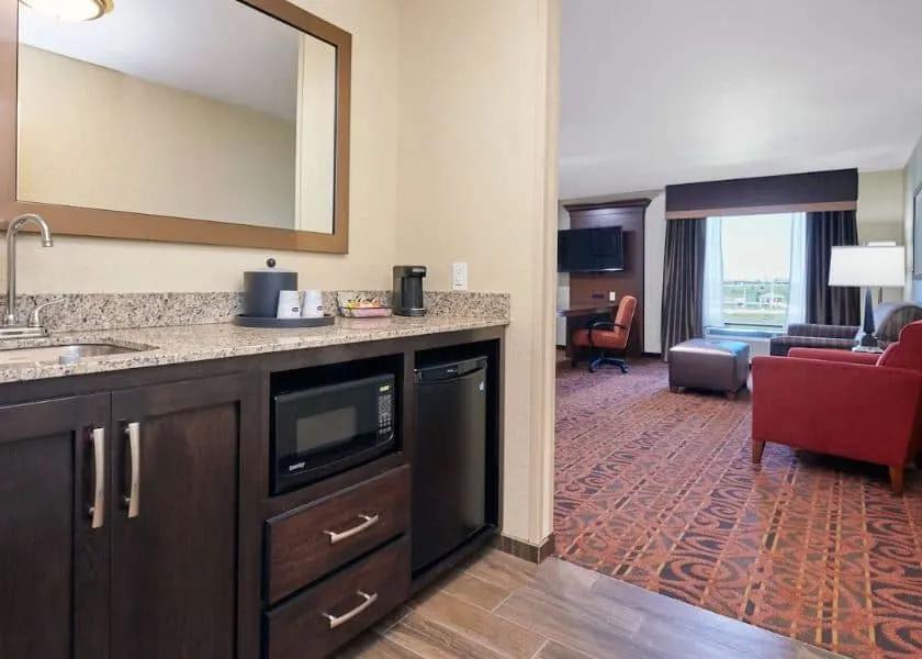 hotel room with bedroom, kitchen and sofa at Hampton Inn & Suites Milwaukee, Wisconsin