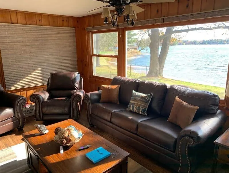 living room with leather sofas and lake view at Beautiful Minocqua Lake House, Wisconsin