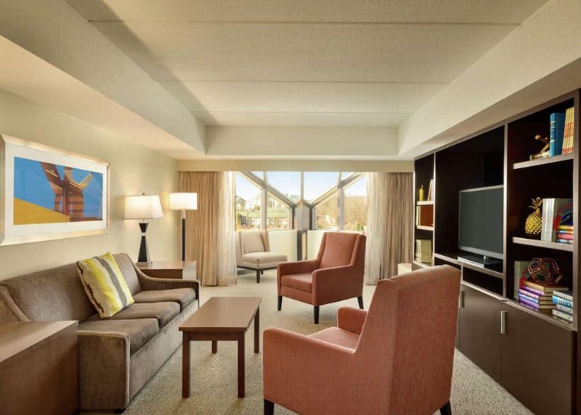 living room with sofa and TV at Embassy Suites by Hilton Milwaukee, Wisconsin