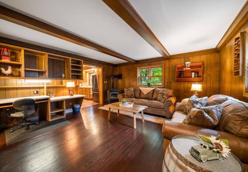 wooden living room with sofas, desk and fire place at the Spacious Family Friendly Home, Wausau, Wisconsin