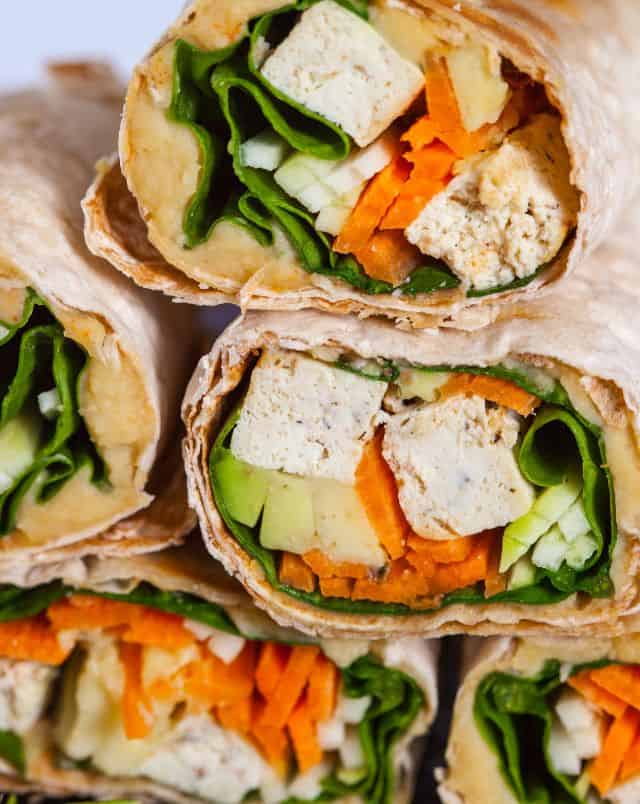 cafes in Milwaukee Wisconsin, Close up shot of a pile of several tortilla wraps containing tofu and lettuce as well as diced carrot and cucumber