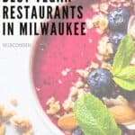 Pin with image of a vegan dessert bowl containing blueberries, almonds and mint leaves, caption reads: Guide to the Best Vegan Restaurants in Milwaukee Wisconsin from Paulinaontheroad.com