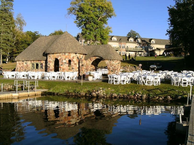 grounds at Tagalong Golf Resort & Conference Center with a lake and dining area in Northwest Wisconsin