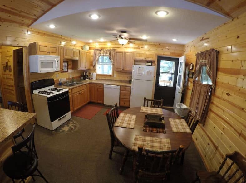 kitchen with dining table and fully equipped at Timber Bay Resort in Cable, Wisconsin
