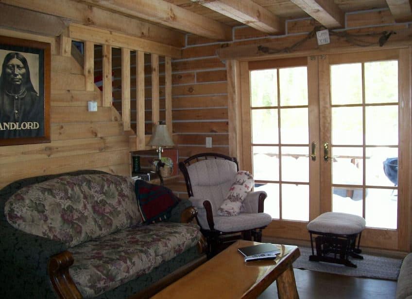 living room with sofa and armchair at the Private Amish Log Cabin - Black River Falls, Wisconsin