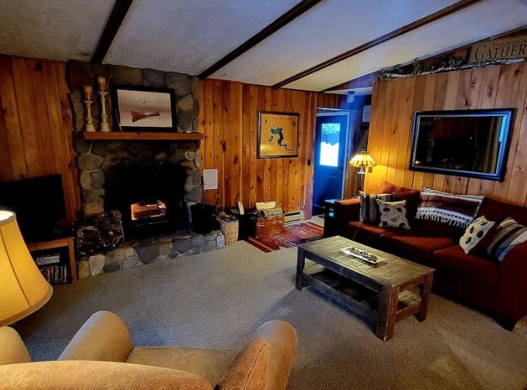 living room with sofa and fire place at one of the best log cabin rentals in Wisconsin