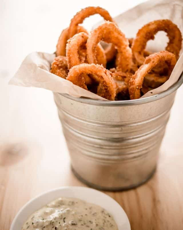 best vegan Milwaukee restaurants, Small metal bucket containing fried onion rings with a small white ceramic bowl of dipping sauce to the side