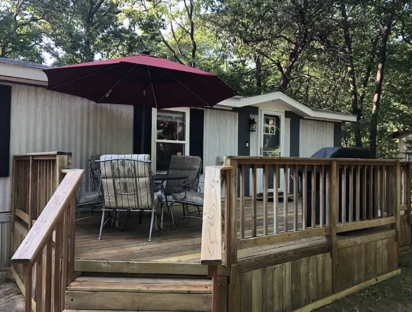 porch area with dining table and grill at Arbor Lake Getaway in Wisconsin Dells