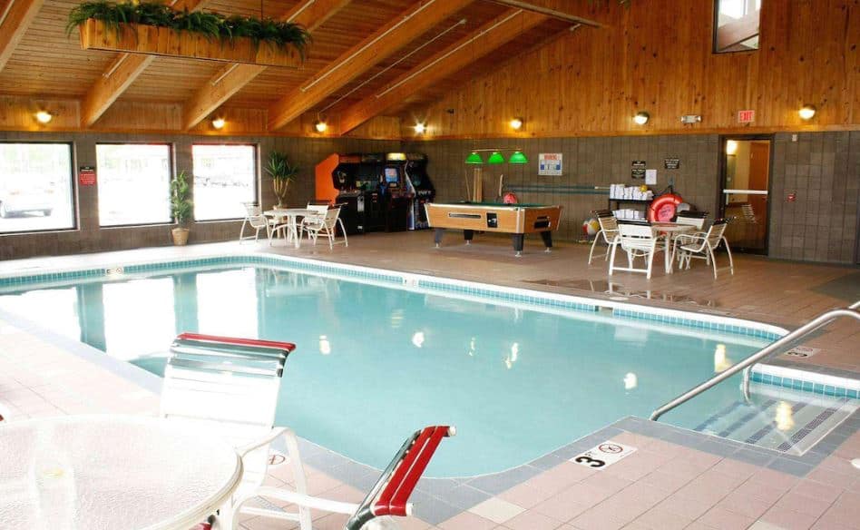 recreational area with indoor pool, pool table and arcade at AmericInn by Wyndham Sturgeon Bay, Wisconsin