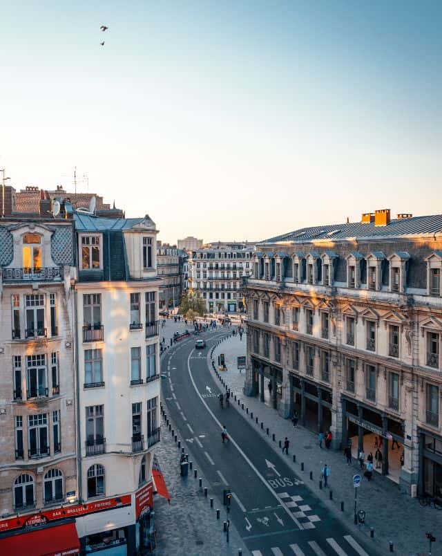 Make the most of some of these short trips from Luxembourg, view looking down on an area of road winding through tall residential and office buildings in Lille