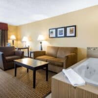 bedroom with hot tub and sofas at one of the best winter resorts in Wisconsin Dells