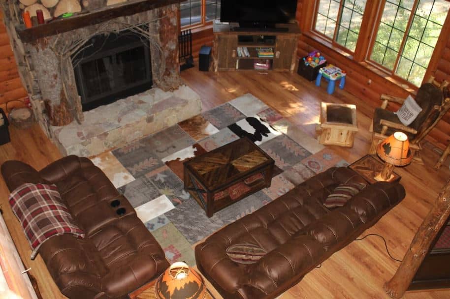 living room with wooden walls, sofas, fire place at the Family-Friendly Log Cabin, Lake Geneva, Wisconsin
