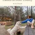a pin with a woman playing with her dog outside one of the best pet-friendly cabins in Door County, WI