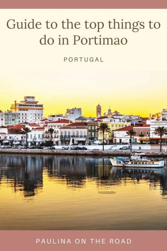 Pin with image of a tightly packed group of residential buildings mostly painted white with red rooftops sitting on the banks of a still river reflecting the buildings and the burnt amber yellow sky, caption reads: Guide to the top things to do in Portimao, Portugal from Paulina on the Road