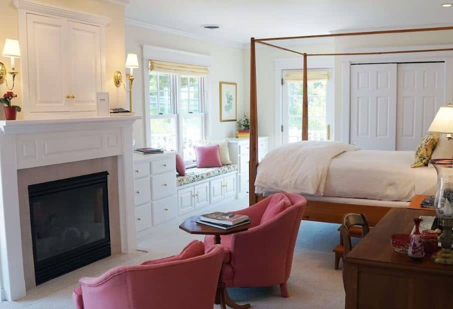 romantic places to stay in Door County, bedroom with bed and fire place at Hillside Waterfront Hotel in Ephraim, WI