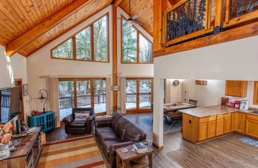 big open space area with living room and kitchen at secluded cabin in the woods in Egg Harbor, WI