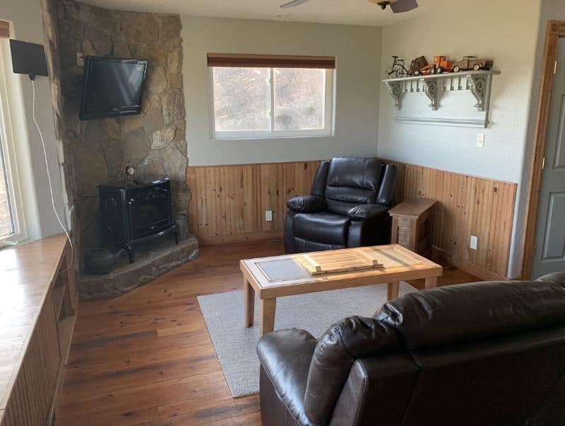 cozy living room with fire place and sofas at Country Cabin with Panoramic Views in Sparta, WI