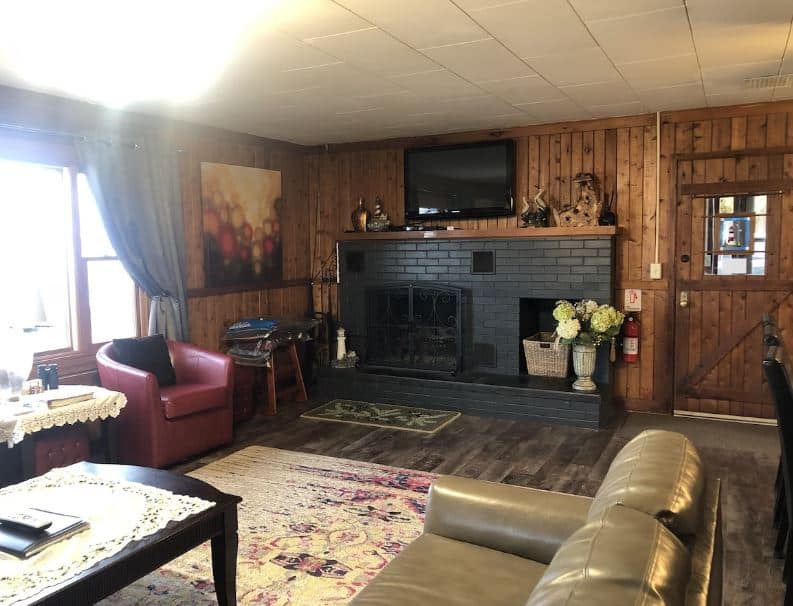 cozy living room with fire place at Waterfront Swedish-style Log Cabin on Sand Bay in Sturgeon Bay, WI