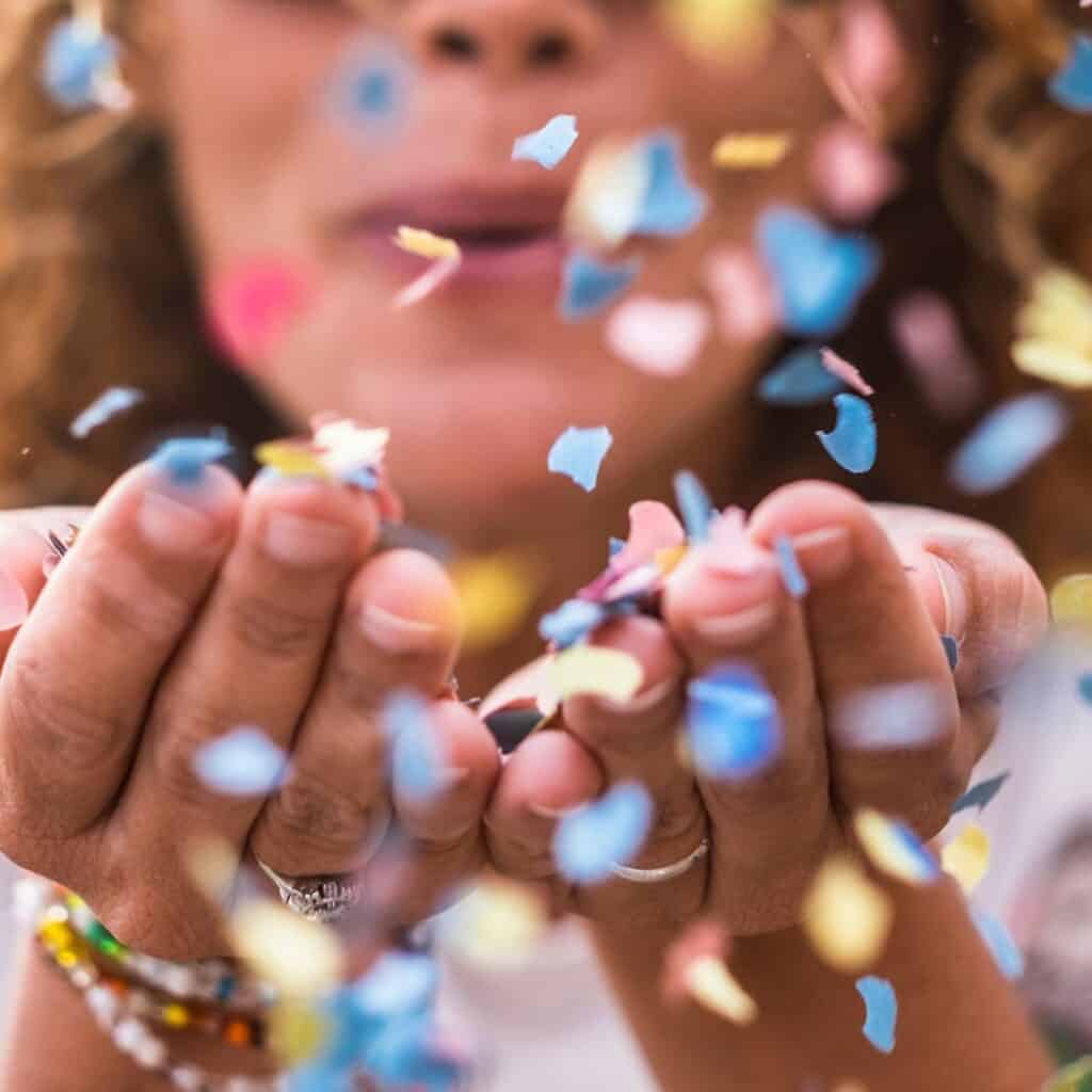 events, festival, celebration, woman blowing confetti