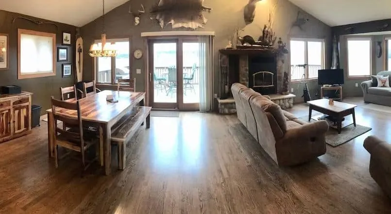 living room with sitting area, sofa, TV and fire place at Private Cabin on Lake Superior in Ashland, WI