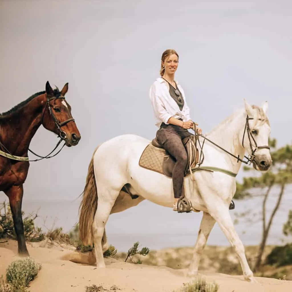 horse back riding paulina travel blogger, a woman riding a white horse