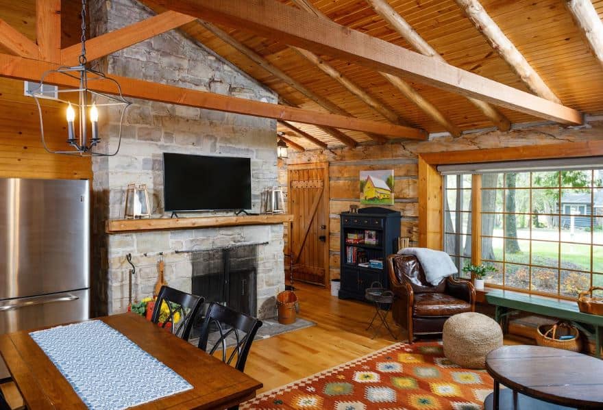 wooden living room with fire place at the Adorable Pet-Friendly Cottage in Ephraim, WI