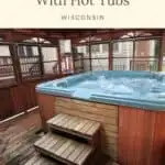 a pin with a hot tub on a patio at one of the one of the best Door County cabins with hot tubs.