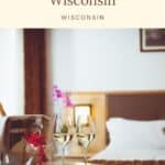 a pin with 2 glasses of champagne by the bed at one of the most romantic resorts in Wisconsin