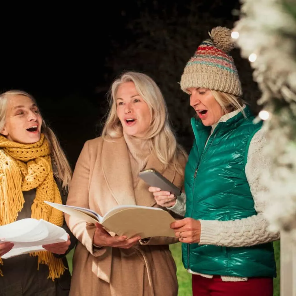 three adults Christmas Caroling