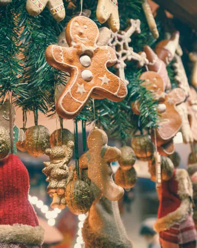 best Christmas Market Wisconsin, Close up shot of gingerbread men and ornaments hanging by string from the roof of a stall at a Christmas market