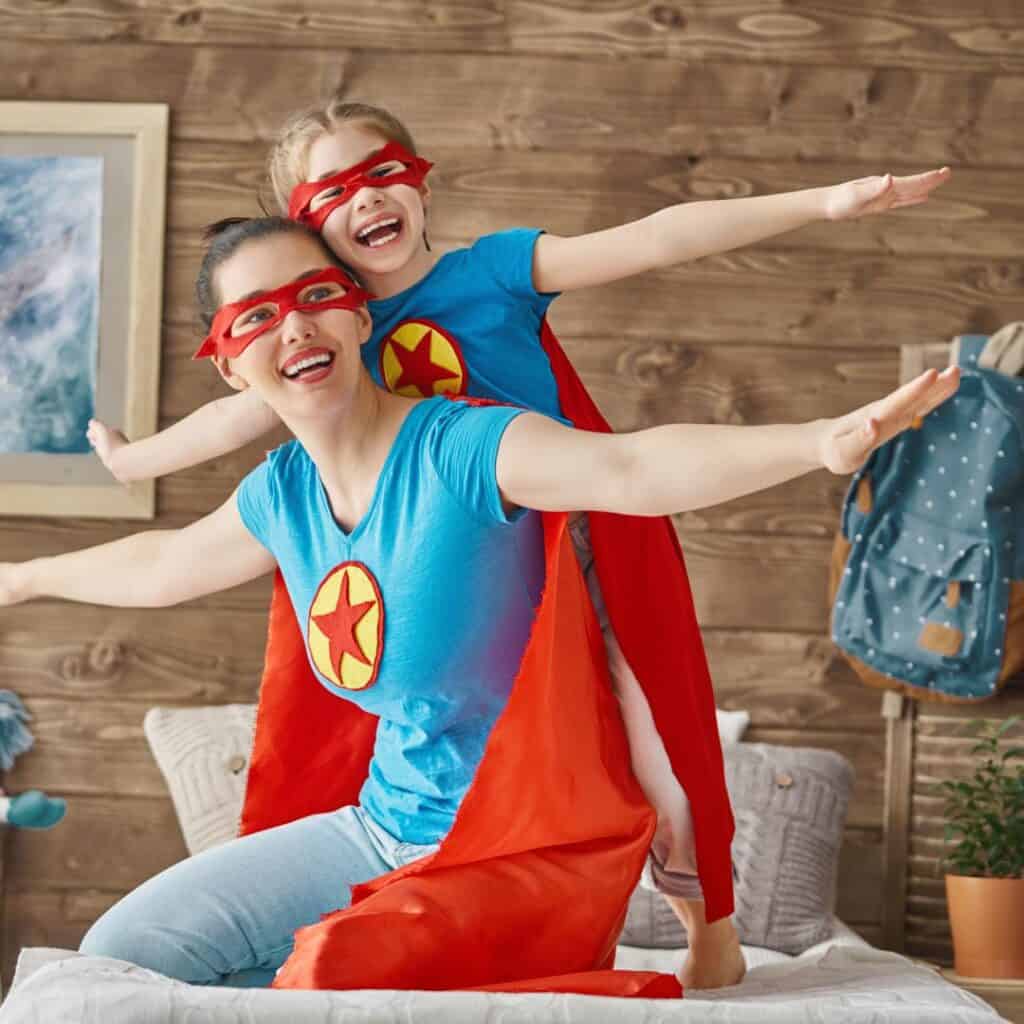 a mom and a daughter wearing super hero costumes