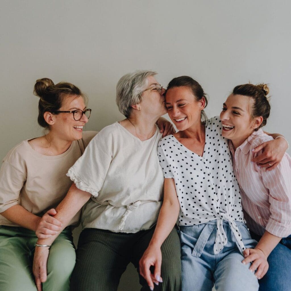 3 daughters enjoying time together with their old mother