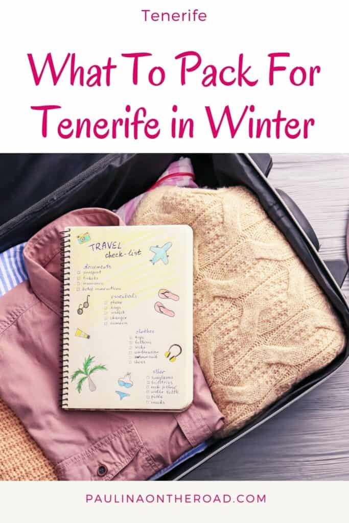 a notebook with a packing list on top of a pink jacket, peach cardigan, and some clothes in a luggage