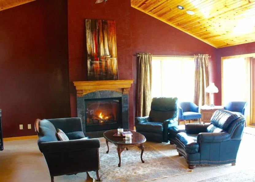 cozy living room with sofas in front of a fire place at one of the best honeymoon cabins in wisconsin