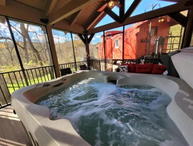 hot tub with view of the 1954 Rail Road Caboose Cabin with Relaxing Hot Tub in Aspen, Wisconsin