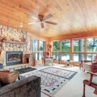 interior of the living room with fire place and lake view at the Lakefront cabin with fireplace in Eagle River, Wisconsin