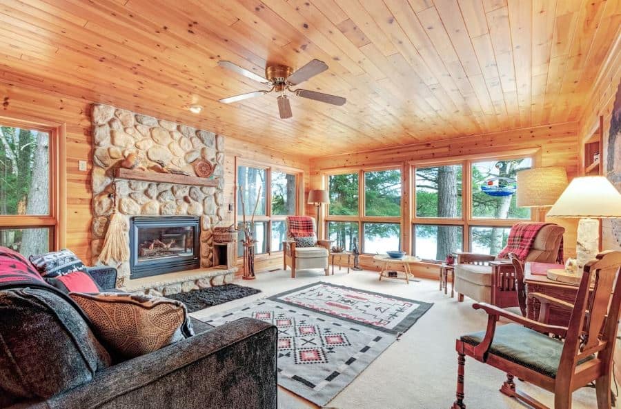 interior of the living room with fire place and lake view at the Lakefront cabin with fireplace in Eagle River, Wisconsin