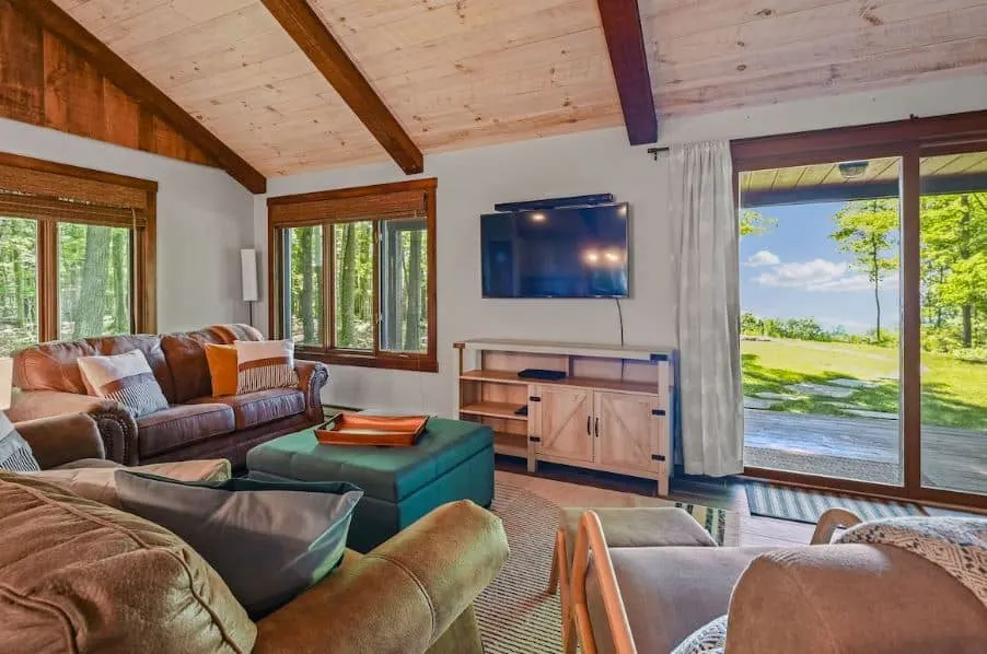living room area with sofa, TV with garden view at Wooden Cabin in Egg Harbor, Door County