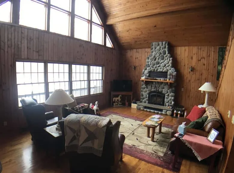 living room with sofa in front of a fireplace at Unique Cabin in the Woods in Pepin, Wisconsin