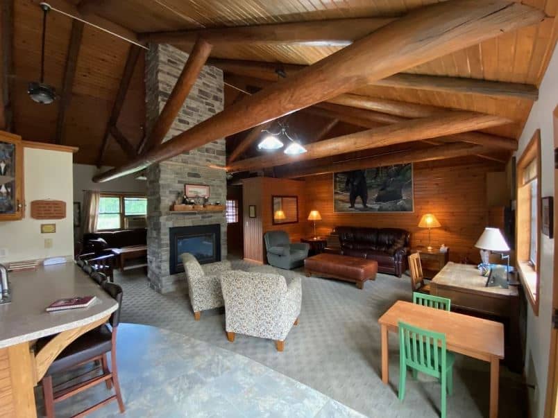 wooded living room with fire place, sofas and desks at Peaceful, Quiet Retreat in the North Woods, Wisconsin